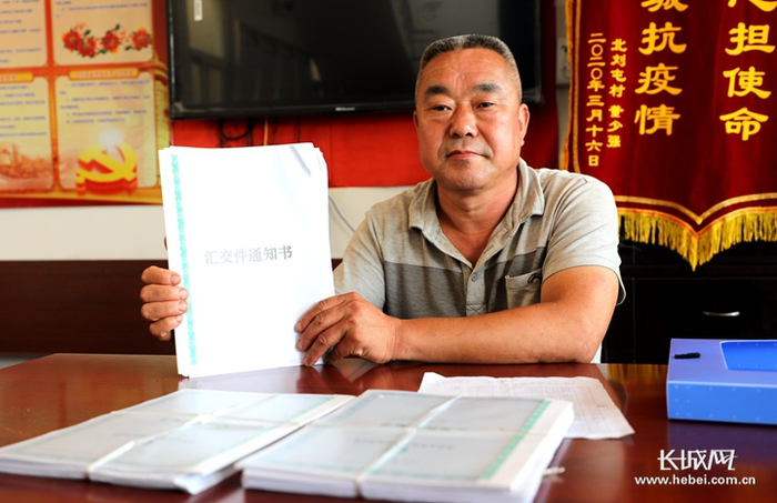 节固乡北刘屯村党支部书记、村主任董廷江介绍该村投保情况。长城网记者 烟成群 摄