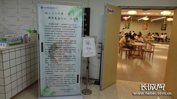 餐厅门口设立“制止餐饮浪费 践行光盘行动”倡议书展架。长城网记者 许晓星 摄