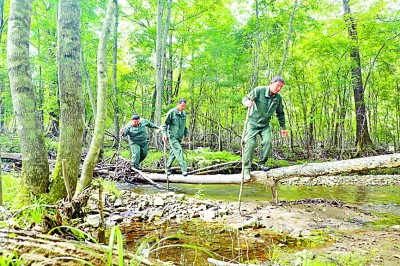 马滴达保护站的工作人员在山中巡视  记者 姜奕名摄