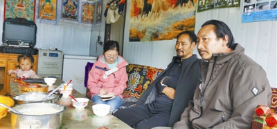 记者采访生态管护员丹增（中）。 刘露菲摄