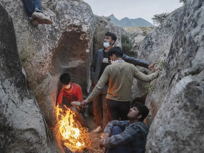  2021年8月6日，土耳其凡城附近，几名阿富汗人藏在岩石后躲避土耳其警方搜索。图源：世界报