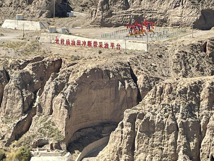 在玉门老市区的西南端，老油田已经建成了红色旅游景区。“老君庙油田冲断带采油平台”这个红色的招牌架在山坡上。新京报记者 苑苏文摄