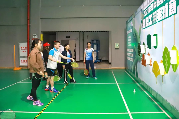 ▲赛场一侧参加趣味羽毛球挑战活动的老师们（聂竹君 摄）