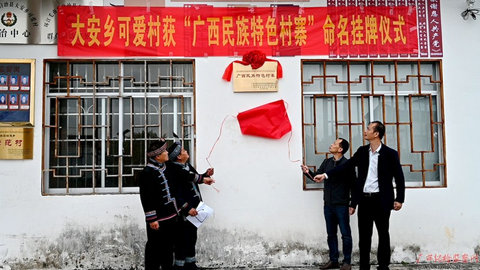 可爱村举行“广西民族特色村寨”挂牌仪式，村民们脸上洋溢着幸福笑容。（莫薇玲/摄）