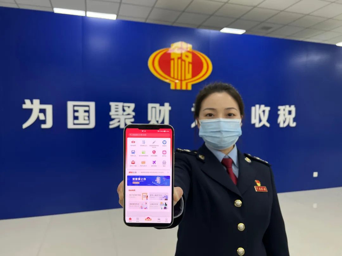 图为国家税务总局洛阳市税务局第二税务分局干部展示掌上办税平台。