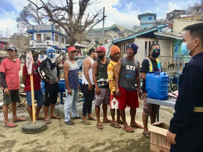 当地时间2021年12月21日，菲律宾迪纳加特，村民排队领取食物。图/IC photo