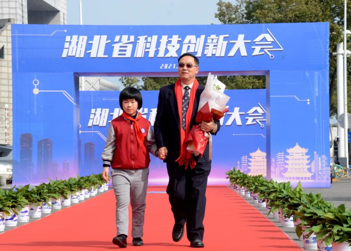 ▲华中农业大学教授、中国科学院院士张启发走上科技红毯（匡敏 摄）