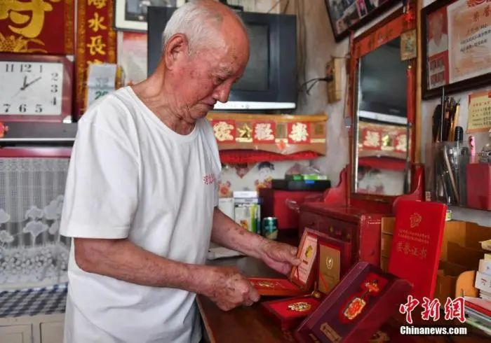 图为5月26日，卢常禄整理军功章。中新社记者 韩冰 摄