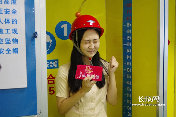 记者正在体验高空坠物安全帽穿戴项目。长城网记者 刘澜澜 摄