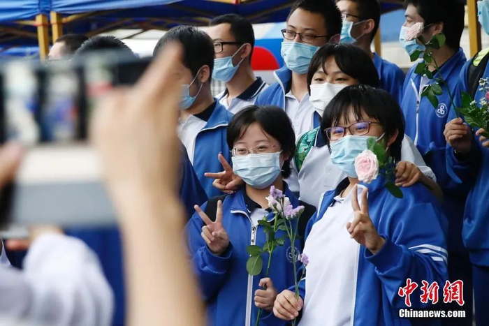 资料图：2020年7月10日，北京第八十中学（望京校区）高考考点外，北京朝阳外国语学校的考生们合影。中新社记者 韩海丹 摄