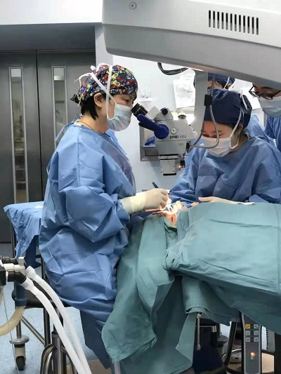 图说：上海市儿童医院眼科主任乔彤为儿童做手术 来源/院方供图
