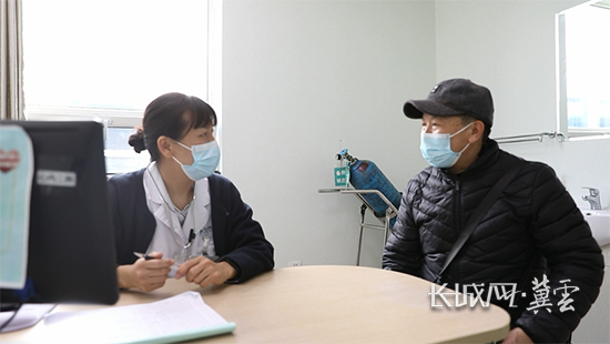 谭琛（左）向刘连海（右）询问病情。长城网·冀云客户端记者 张航 摄