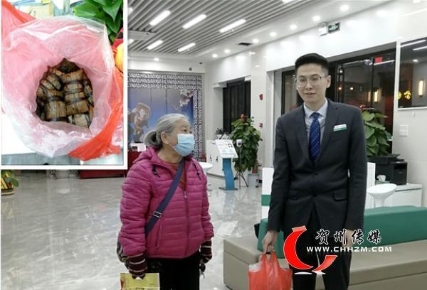 图为老人向农行贺州富川支行营业室送来粽子。