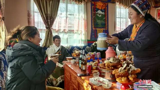 图为普兰新年为家人敬酒。中新社记者 贡桑拉姆 摄