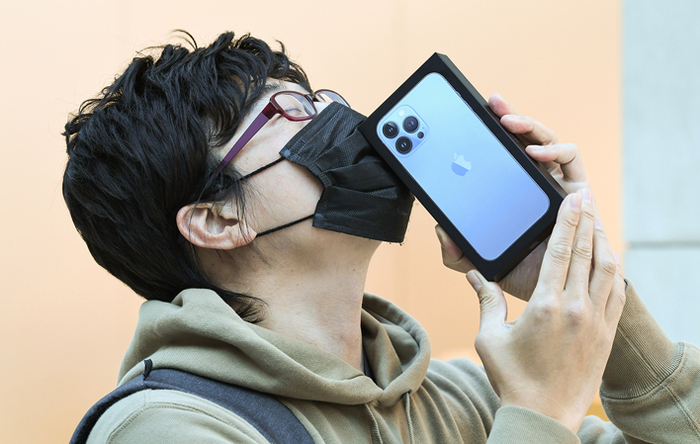 一名“果粉”亲吻自己购买到的苹果手机&nbsp;视觉中国图