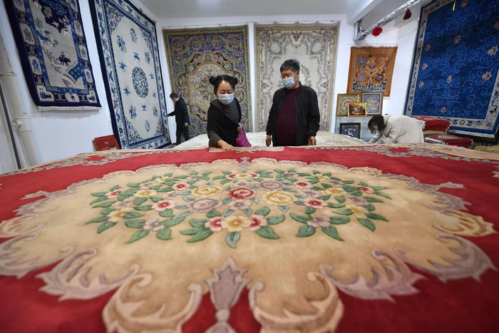 在河北省廊坊市文安县华盛宫毯坊，顾客正在选购宫毯。王晖摄