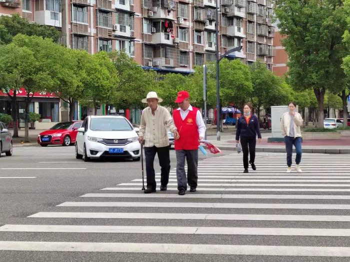 ▲ 四川资阳城区内，某物业公司人员在路口开展文明交通劝导员执勤活动。住房和城乡建设厅供图