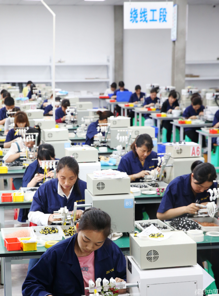 在重庆市某车间制作电子产品的女工们