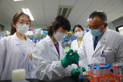 王向东（右一）指导研究生做实验          受访者供图