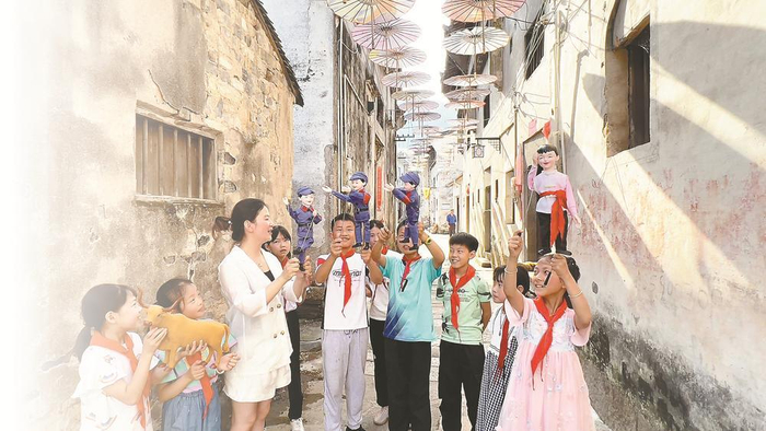 微改造、精提升后的歙县竹铺老街上，当地学生跟着老师学非遗技艺。记者 潘成 摄