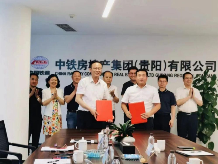 （贵州商学院副校长张勇与贵阳铁建城项目执行总经理罗强代表签约）