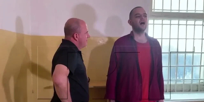 阿斯林（右）唱俄罗斯国歌的画面，图自俄媒