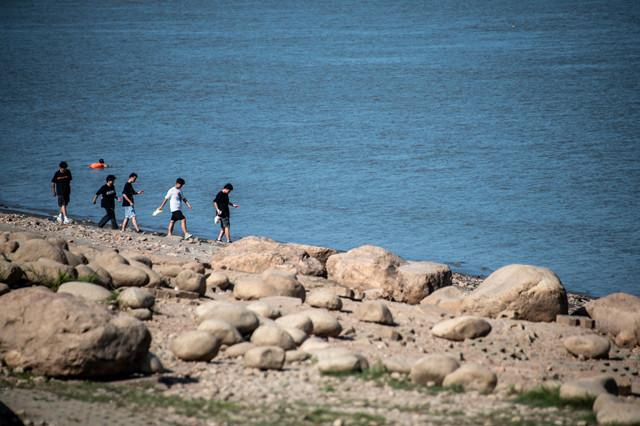 长江武汉段出现历史同期最低水位。8月15日，武汉市民在汉口江滩滩涂游玩。新华社图