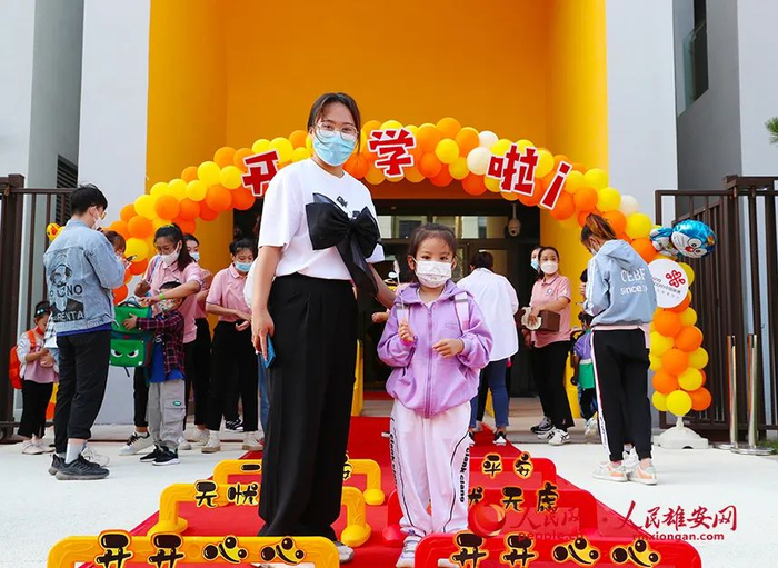 小朋友开心入园。齐鑫摄