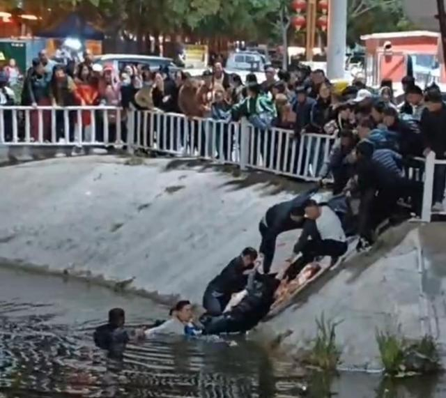 10月17日，人们通过搭“人梯”的方式，手拉手接力救人。网络截图