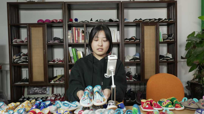 “乡土主播”正在直播销售武邑特产麻糖手工布鞋。　张保卫摄