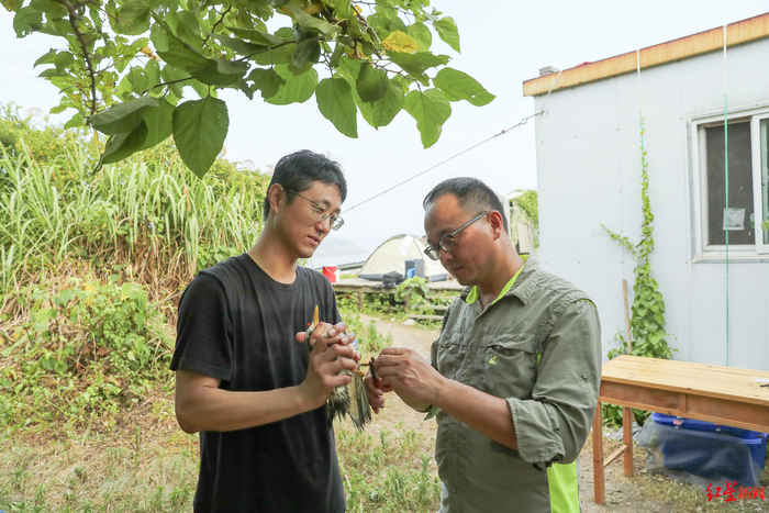 ↑浙江自然博物院研究馆员、中华凤头燕鸥研究和保护项目负责人范忠勇（右）