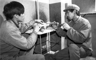 上世纪90年代，工人在给老旧小区安装天然气灶台。 翟伟摄