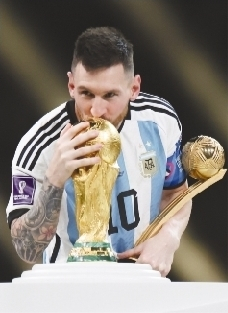         12月19日，获得世界杯金球奖的阿根廷队球员梅西在颁奖仪式上亲吻大力神杯。