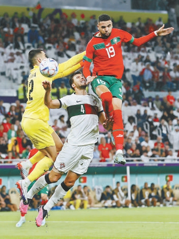 　　四分之一决赛中，摩洛哥队球员恩内斯里（右）一记精彩的头球，帮助球队淘汰葡萄牙队。 东方IC供图