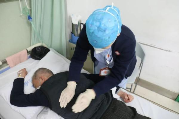 武汉市第一医院呼吸与危重症医学科呼吸三病区护士长贺英为患者示范俯卧位通气。张馨予 摄
