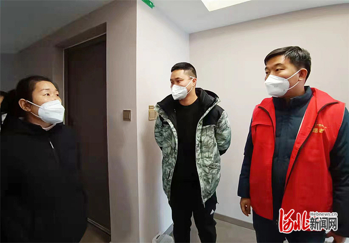 雄安新区容西管委会龙泉社区书记乔明与回迁居民一起查看房屋情况，督促总包方按时按质做好交付工作。  温宇逍摄