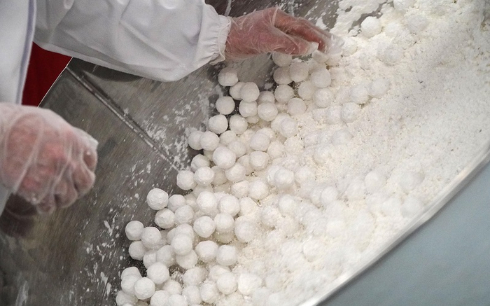 2月1日，在山东省淄博市张店区公园街道的一处传统手工元宵制作销售点，面点师傅现场制作传统手工元宵。新华社记者 徐速绘 摄