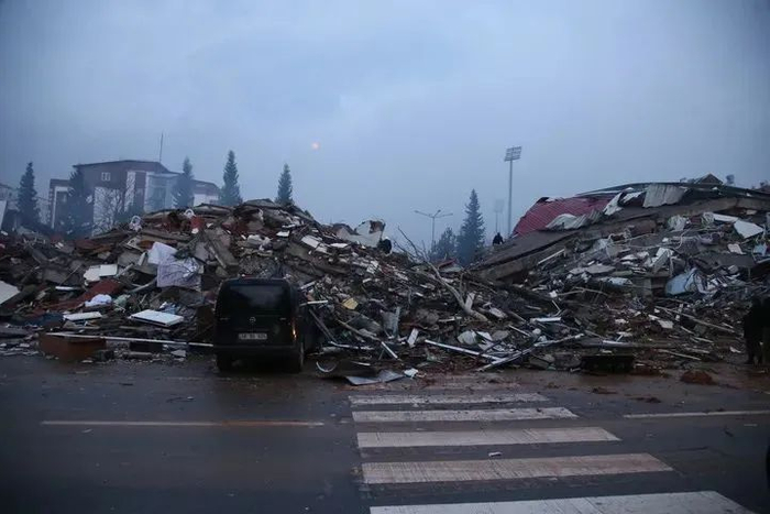 2月7日在土耳其南部卡赫拉曼马拉什市市中心拍摄的震后受损的房屋和汽车。新华社记者 李振北 摄