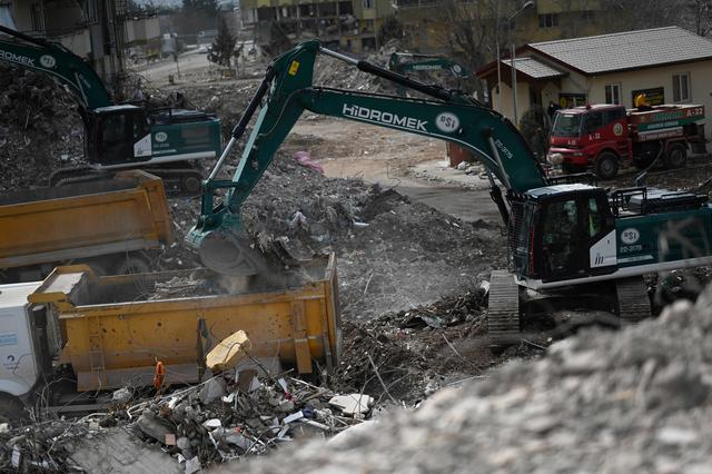 当地时间3月4日，土耳其卡赫拉曼马拉什，工人们操作重型机械清理倒塌的建筑物残骸。图/视觉中国