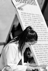 　　2022年4月24日，在甘肃省高校毕业生专场招聘活动现场，招聘单位工作人员查看大学生简历。王将摄/光明图片