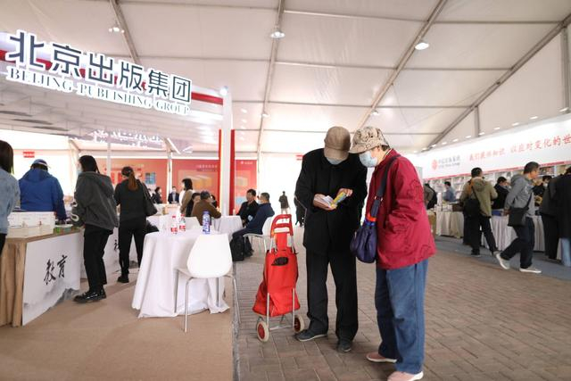 一对老年夫妇在翻看买到的书籍。新京报记者 浦峰 摄 