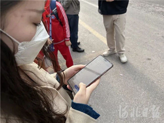 4月17日，在三河市燕郊天洋城广场站，一名乘客正在查看京津冀定制快巴订单信息。通讯员高澍摄