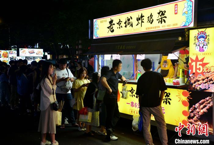 图为民众在福州市达明美食街排队购买美食。张斌 摄