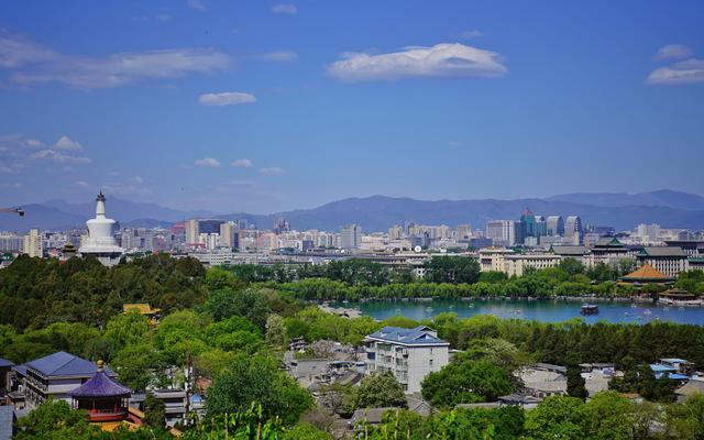 ▲2023年4月30日，从景山公园山顶向西望，北海白塔下不少游客在划船。新京报记者 薛珺 摄