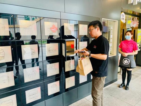 顾客正在麦当劳取餐柜取餐。