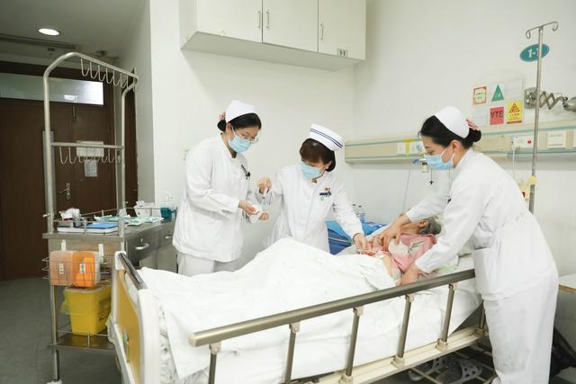北京友谊医院消化内科科护士长韦键（中）正在护理患者。受访者供图