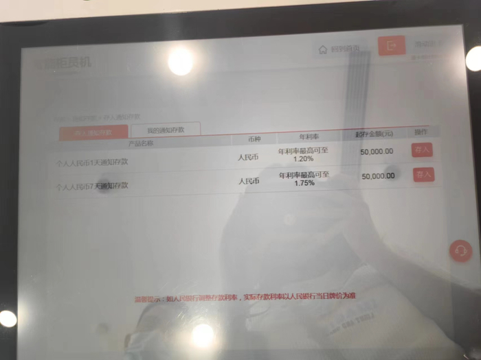 （5月14日下午记者走访时，工商银行上海浦江支行工作人员向记者展示当时的工商银行通知存款利率。李若菡 摄）