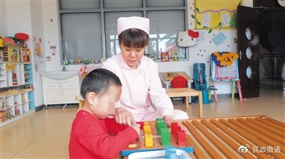 康复师辅助孩子进行手部精细活动训练。受访者供图