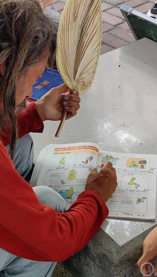 ▲刘彦弘正在给小学三年级学生辅导英语。 摄影/上游新闻记者 张锦