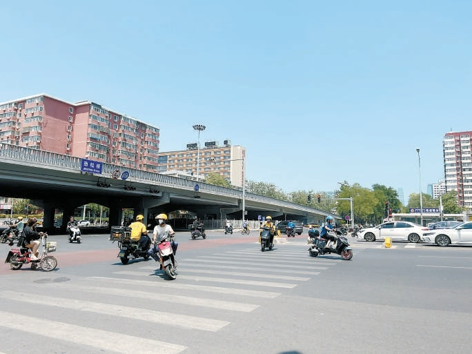 穿行在路口，“与时间赛跑”。 图源：北京日报